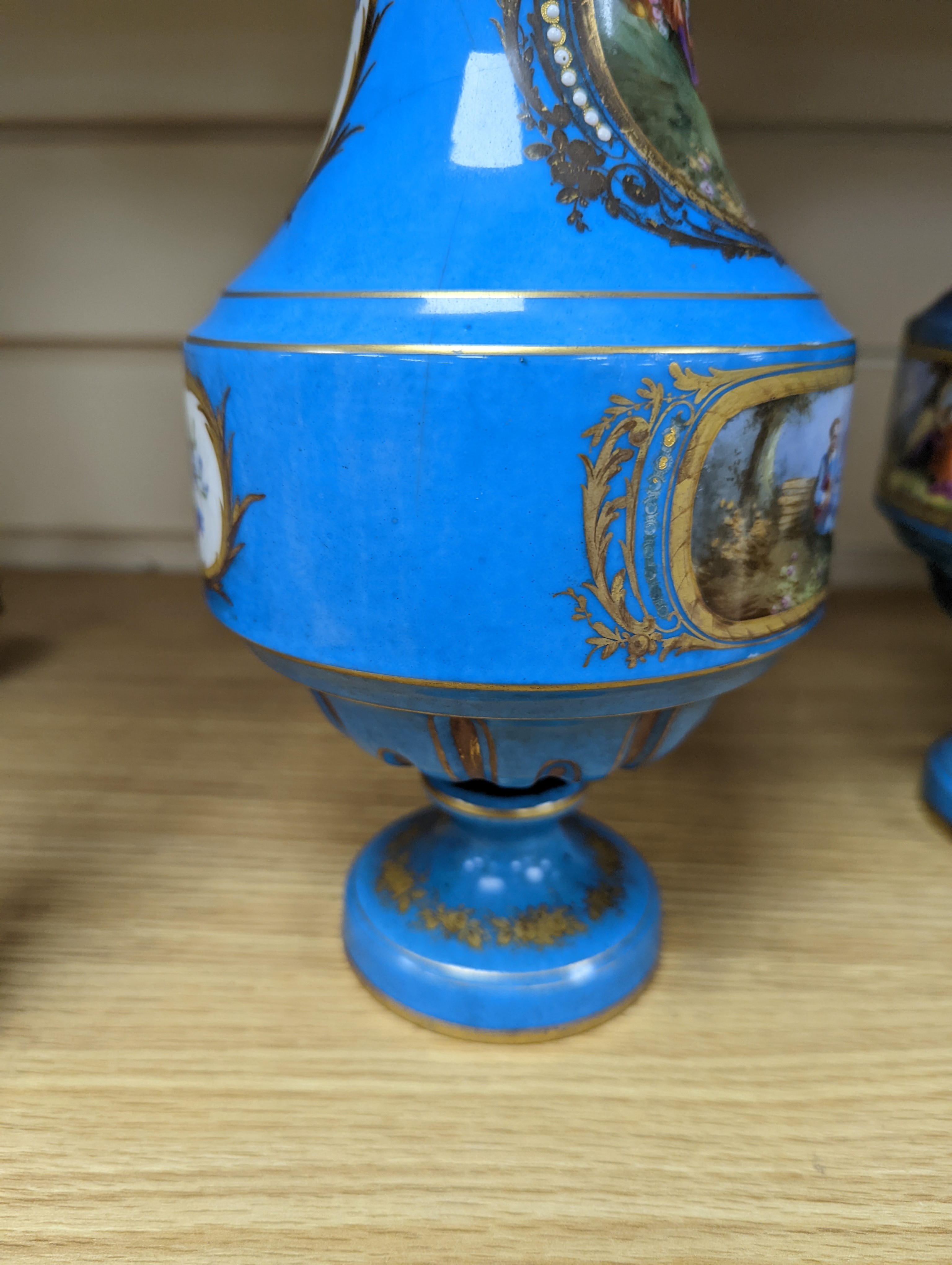 A pair of Sevres style porcelain bleu celeste ground vases and covers, 34cm